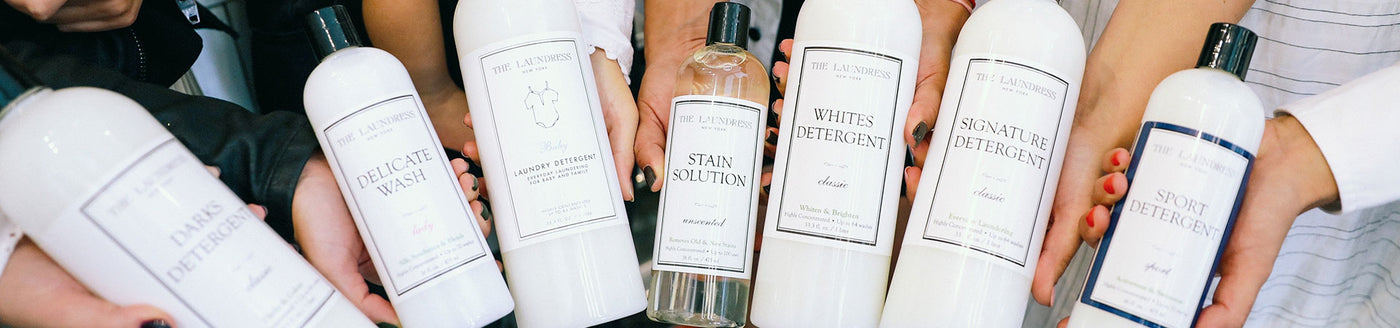The Laundress fabric care solutions, including the Stain Solution, Darks Detergent, and Signature Detergent Classic.