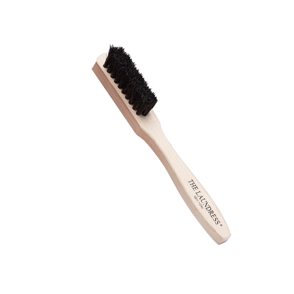 The Laundress Stain Brush with horsehair bristles made to remove stains on washable fabrics.