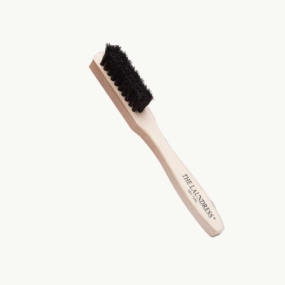 The Laundress Stain Brush with horsehair bristles made to remove stains on washable fabrics.