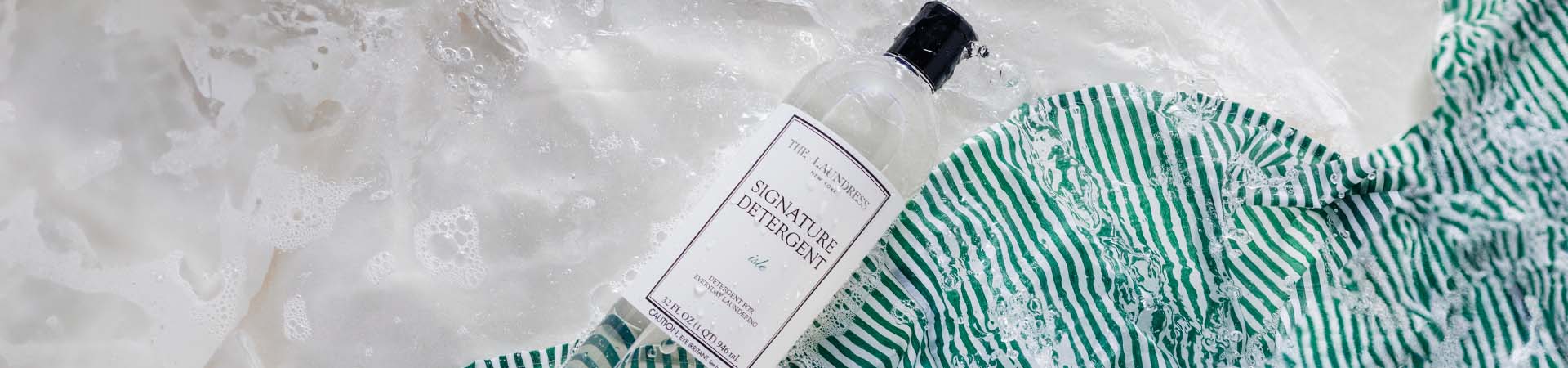 The Laundress Signature Detergent in the scent Isle with notes of heliotrope, jasmine, and sandalwood.