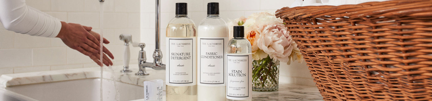 The Laundress Everyday Starter Kit with The Laundress Signature Detergent, Fabric Conditioner, Stain Solution, and Measuring Cup. 