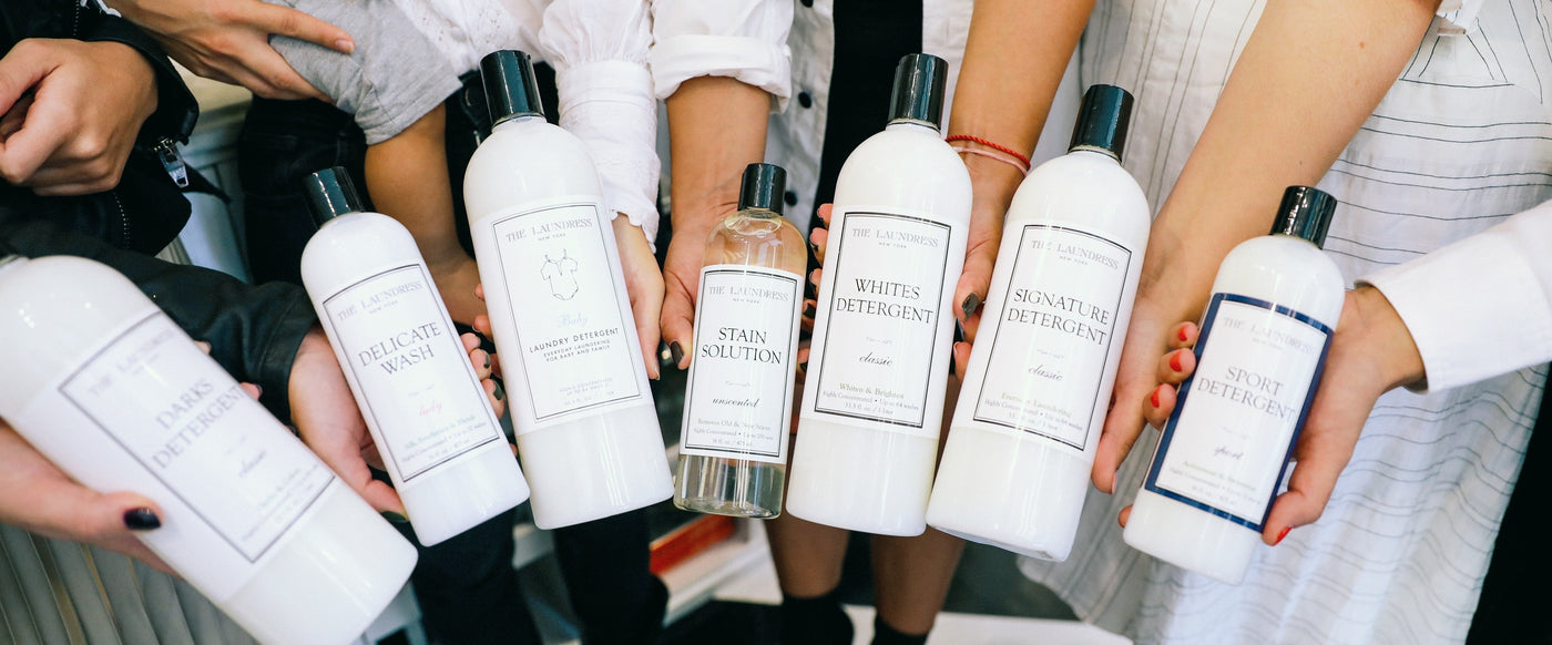 group hand shot of laundress bottles
