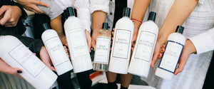 group hand shot of laundress bottles